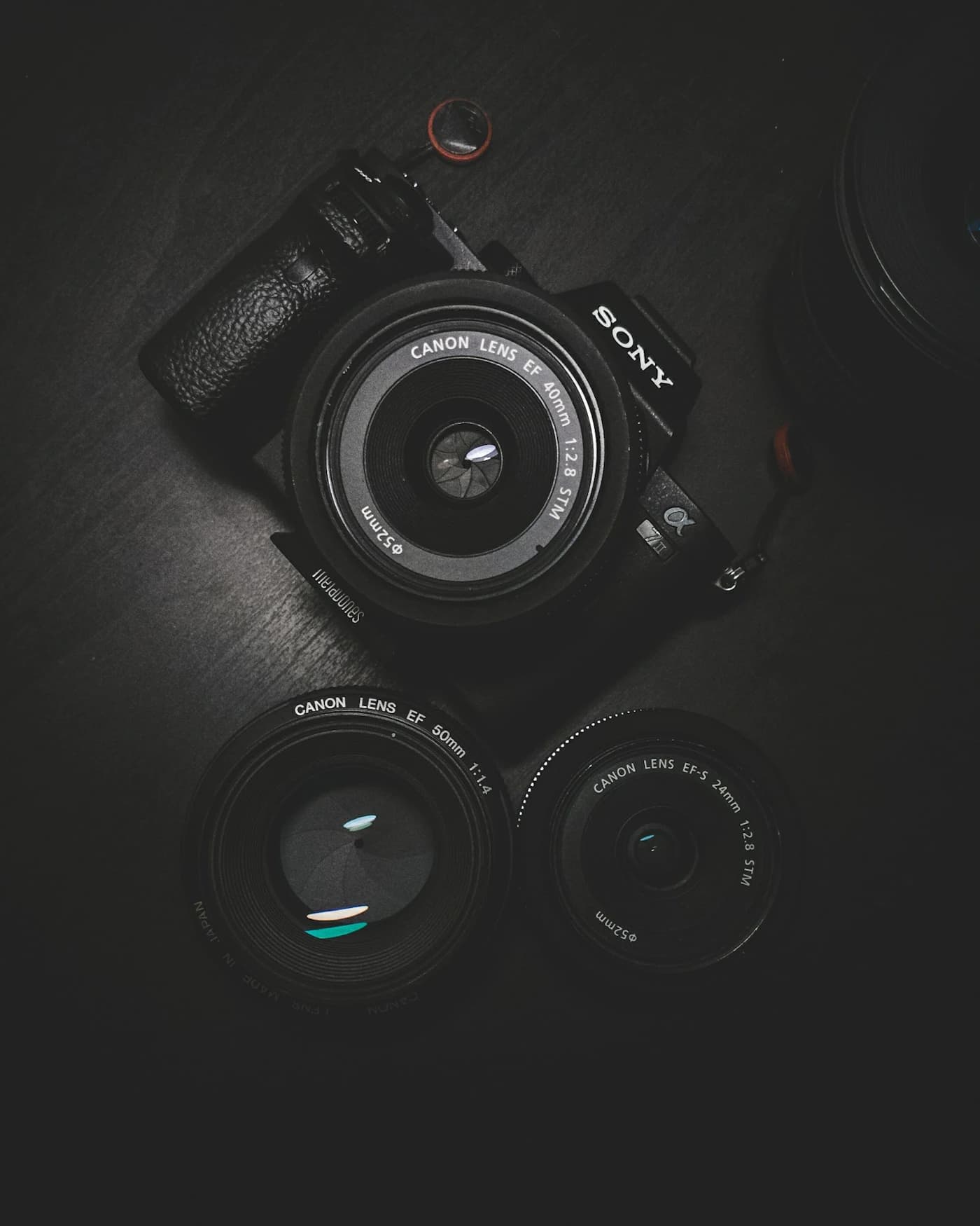 Vintage-style camera and lenses on a dark surface