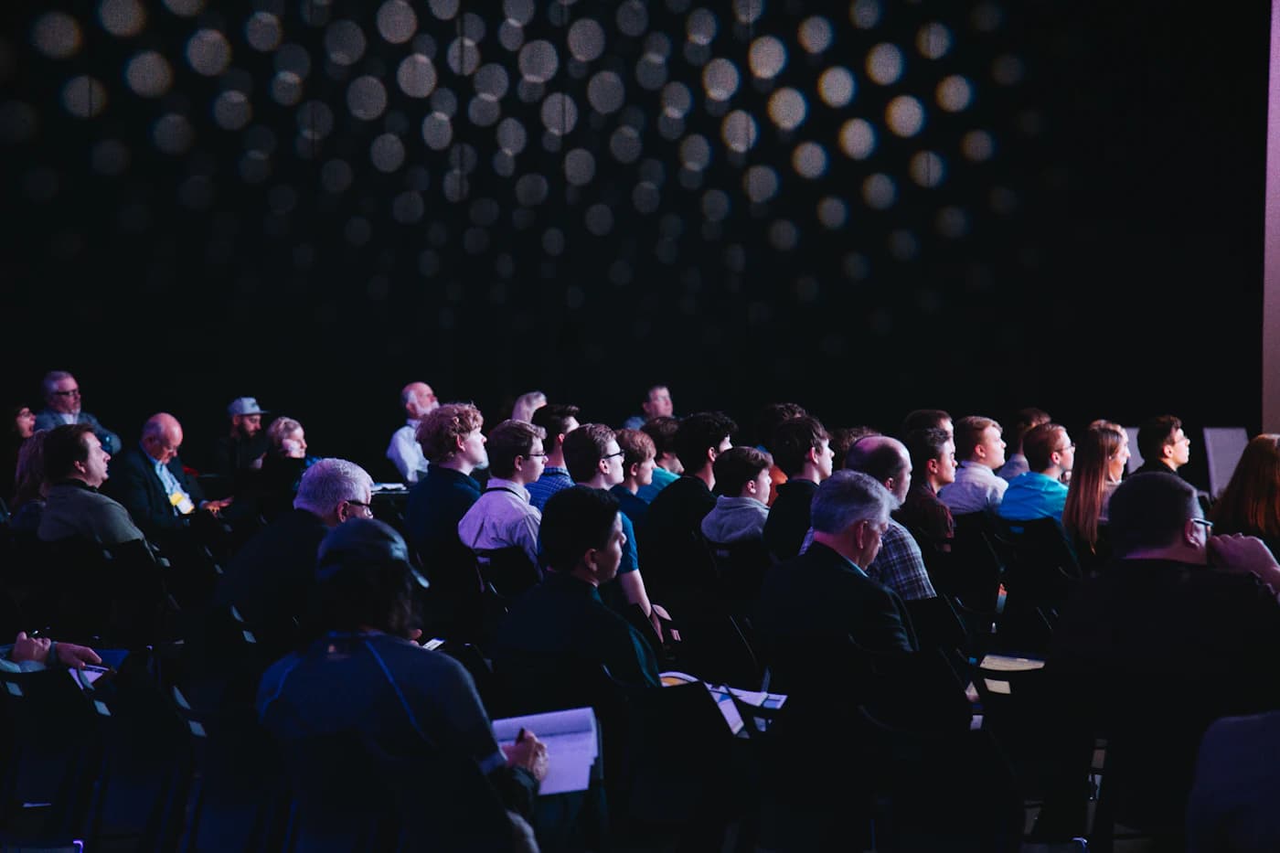 Conference stage with presentation screen and theatre seating
